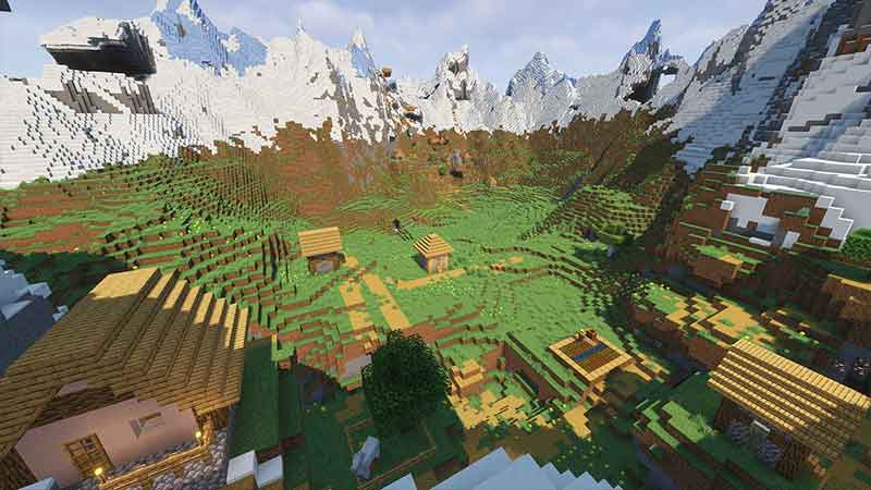 a meadow valley surrounded by frozen peaks with 2 villages inside